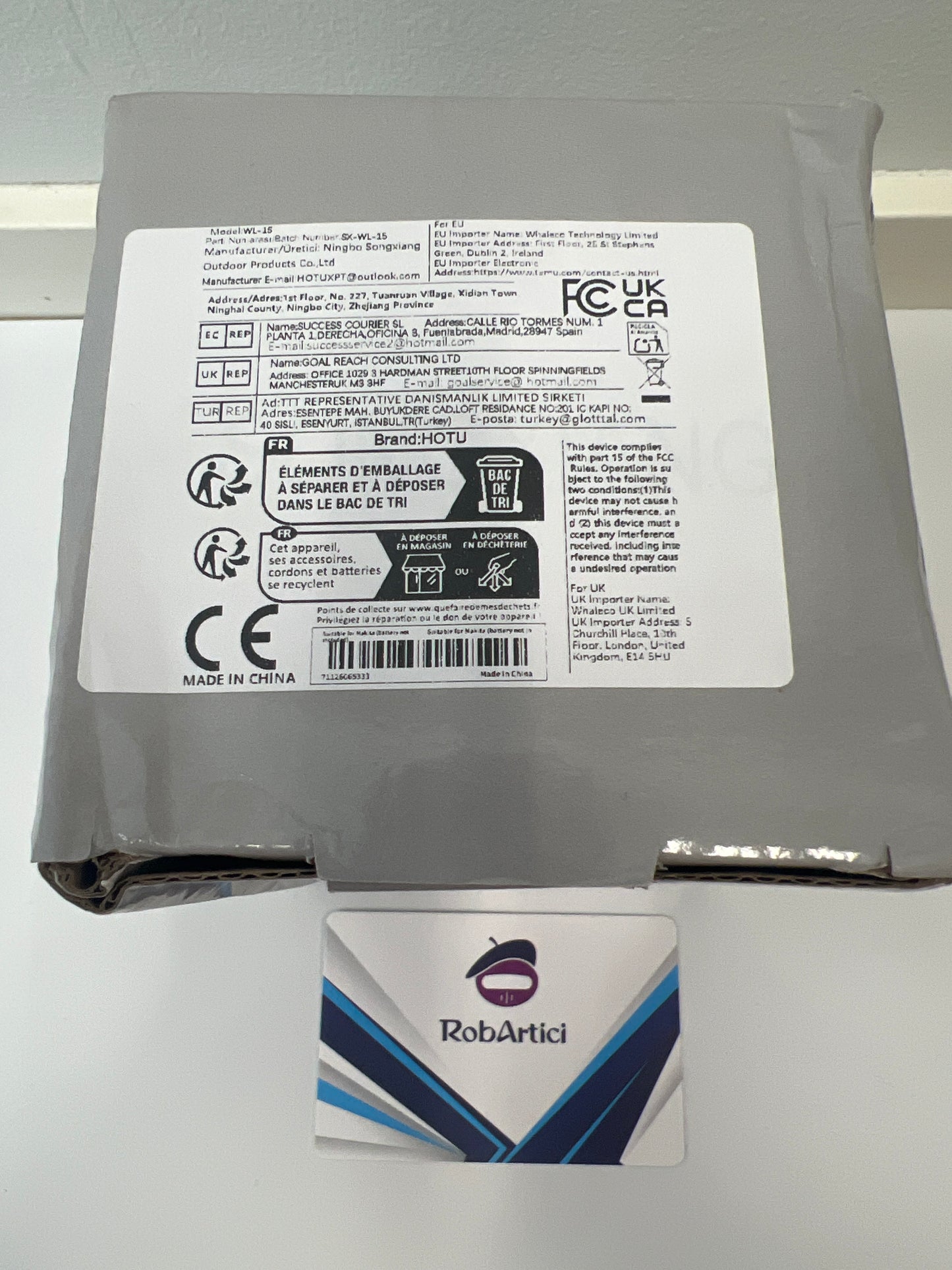 Wide application work light retail packaging showcasing product information.