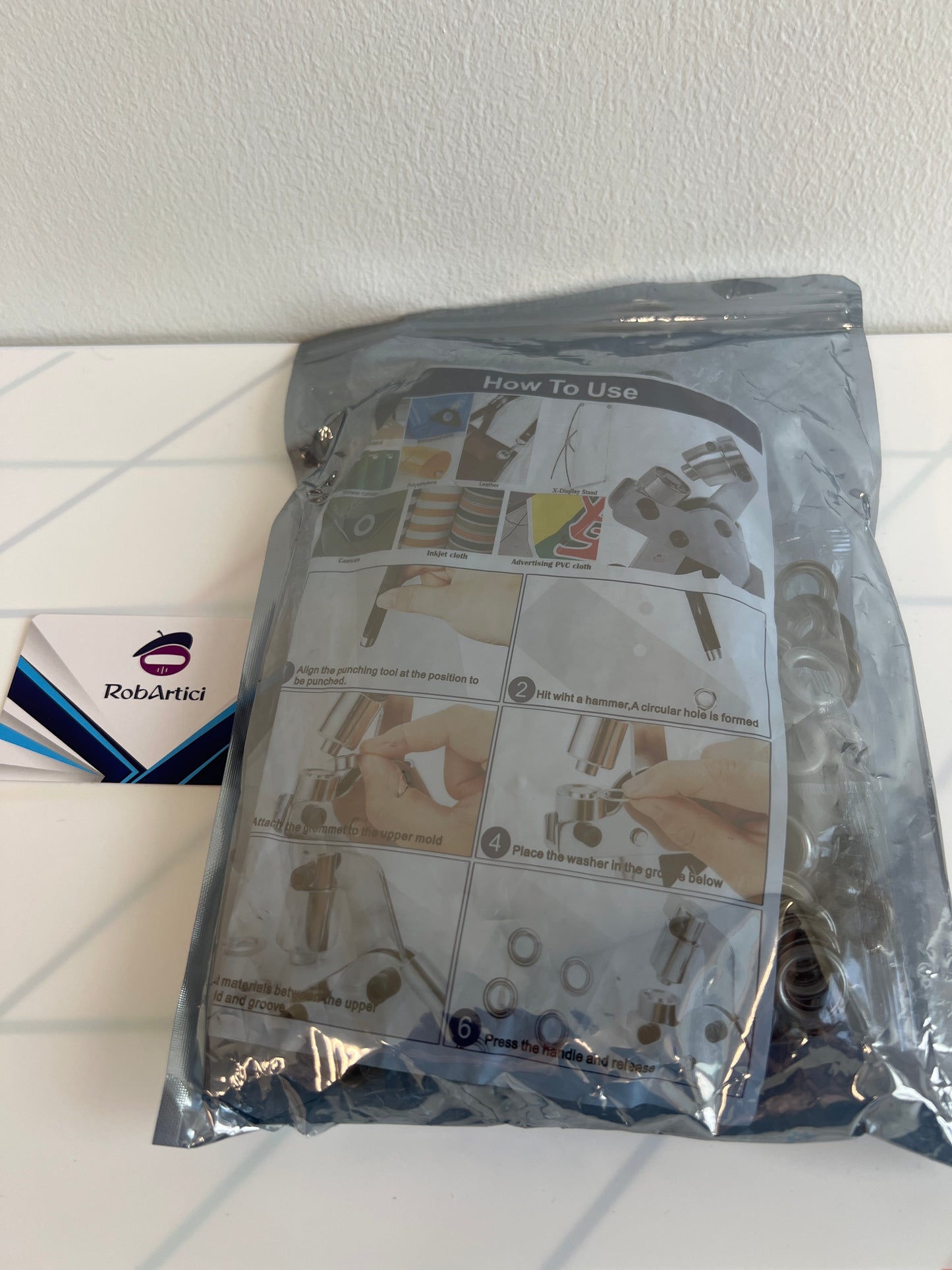 Pliers and grommet DIY tool kit, retail packaging.