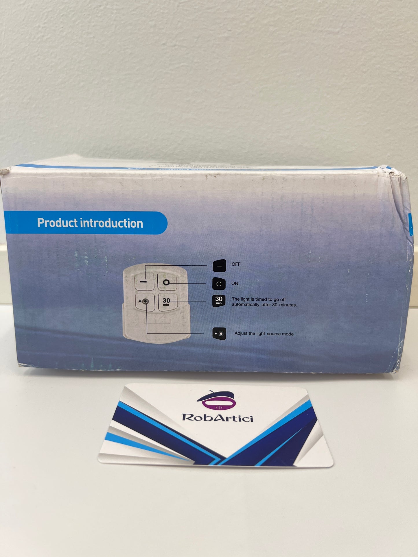 CYCG round LED light retail packaging front view, showcasing how to use the remote control.