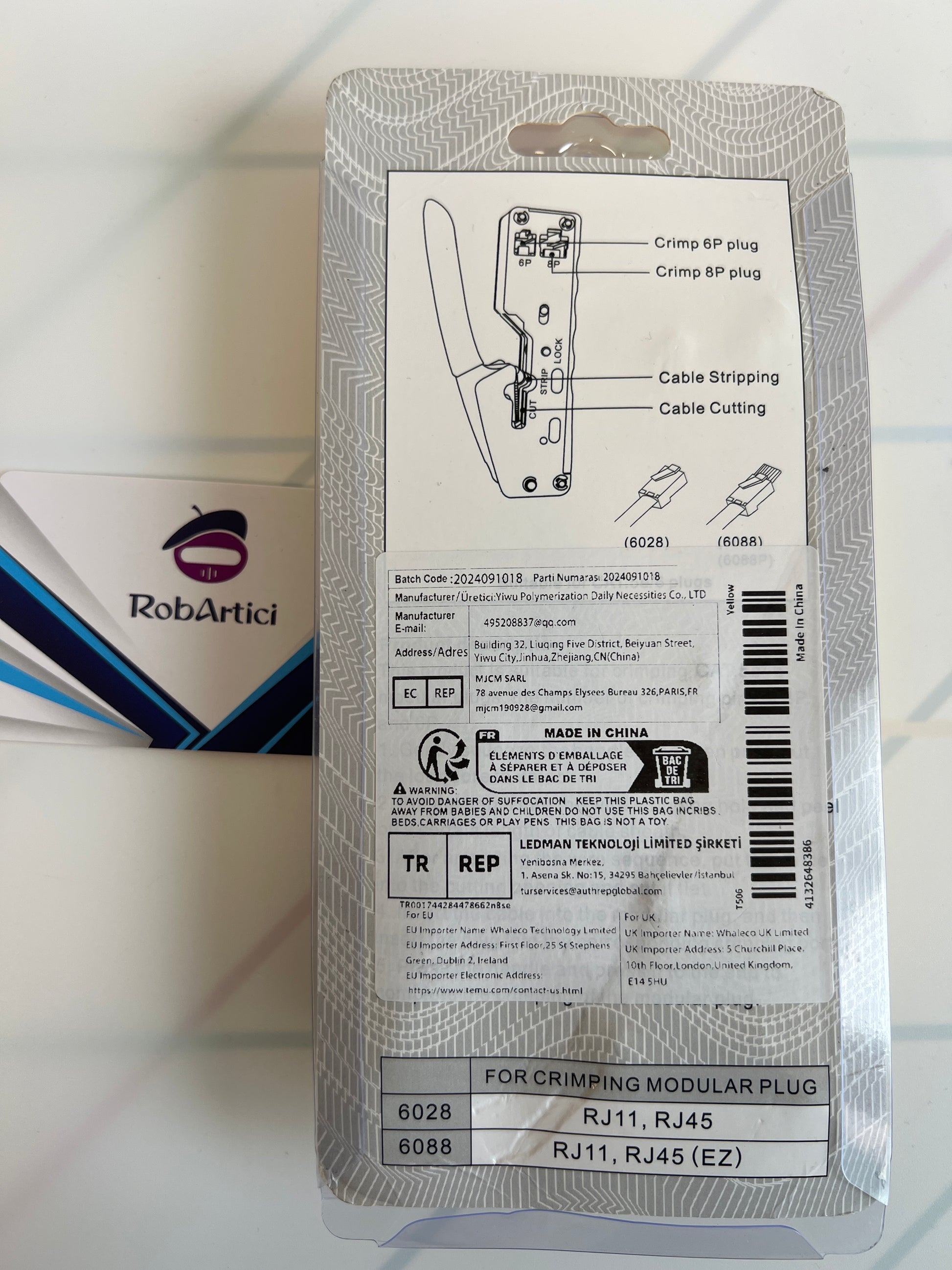 Modular plug crimper tool retail packaging showcasing product information.