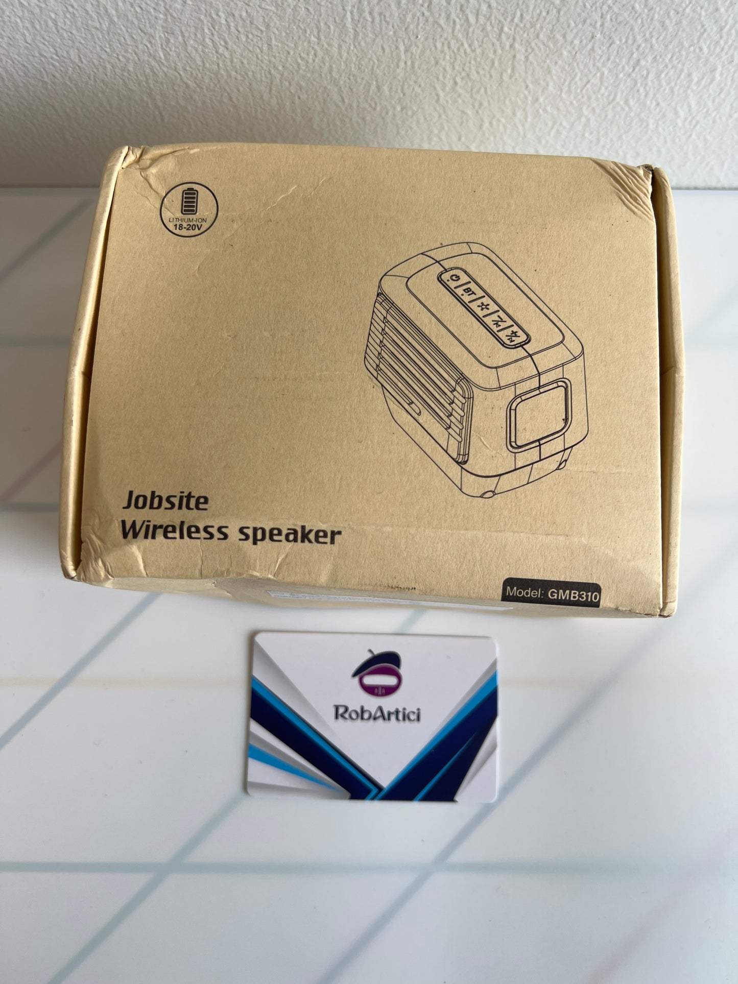 GMB310 job site wireless speaker retail packaging, front view. 