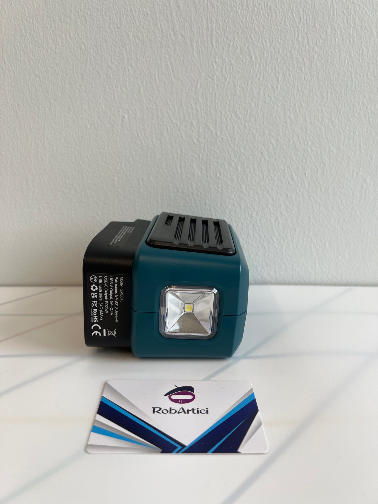 GMB310 job site wireless speaker side view showcasing the integrated LED light panel and product specifications.