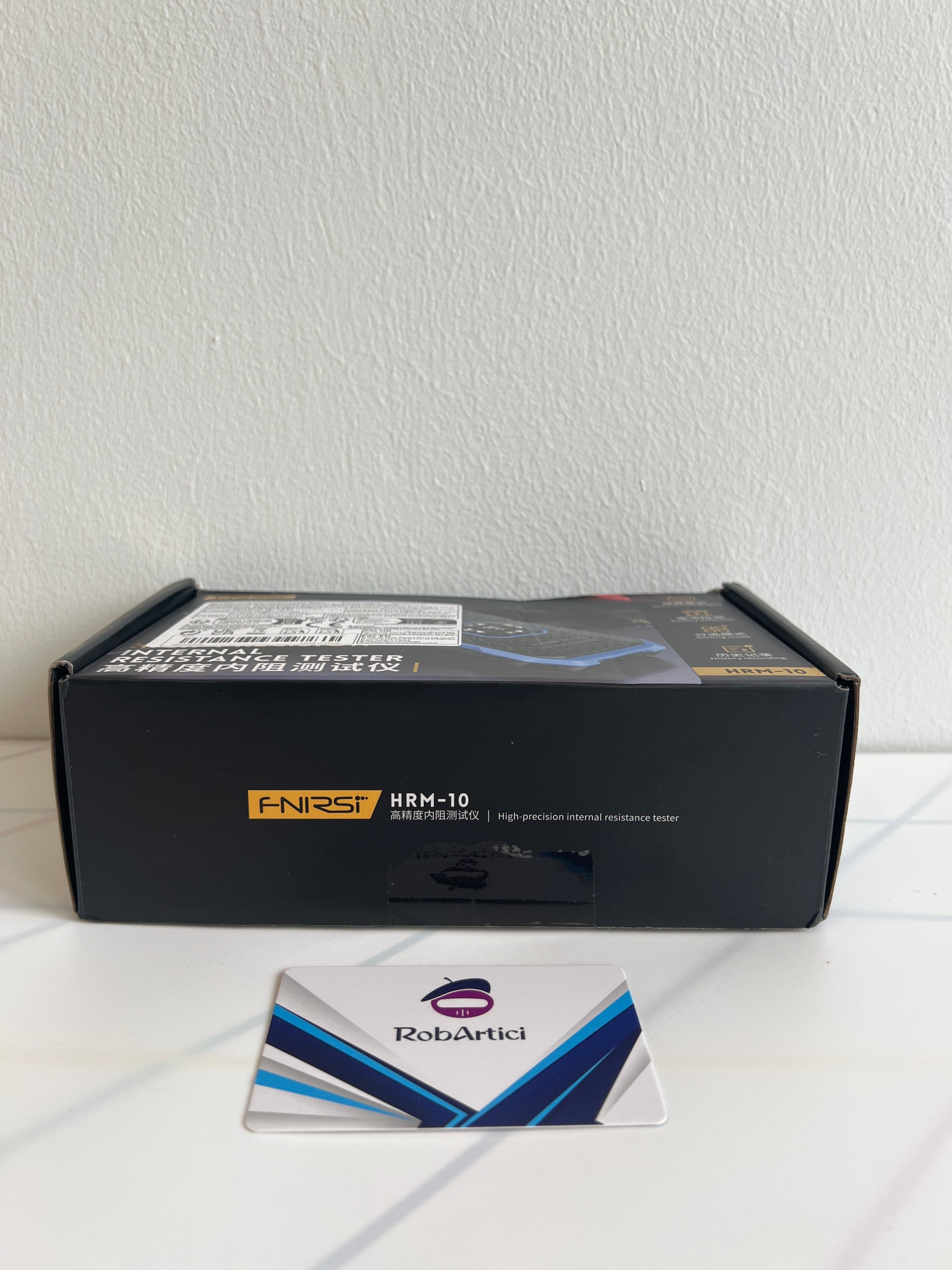 FNIRSI HRM10 internal resistance tester retail packaging.