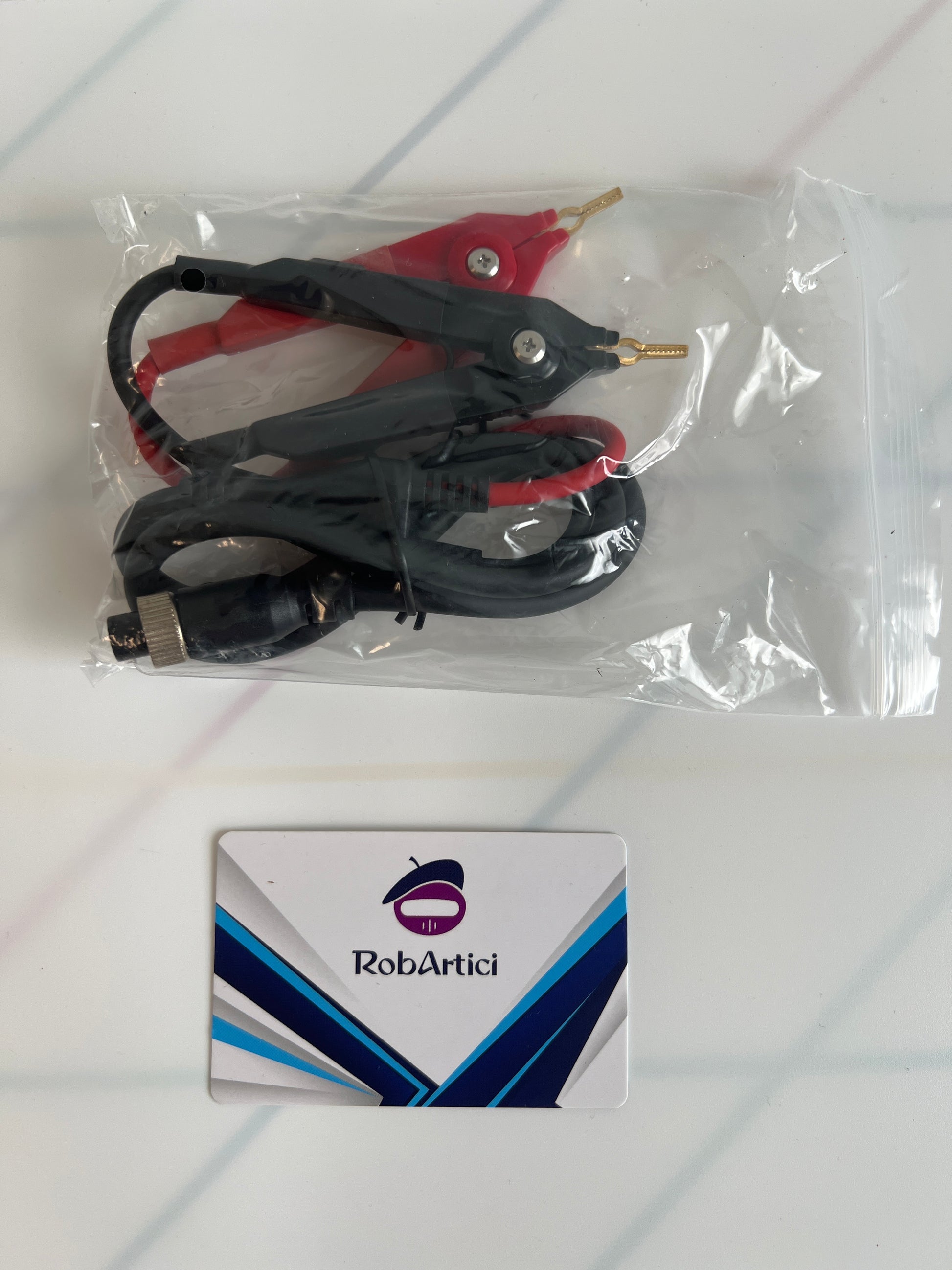 FNIRSI HRM10 internal resistance tester included accessory connection cables.