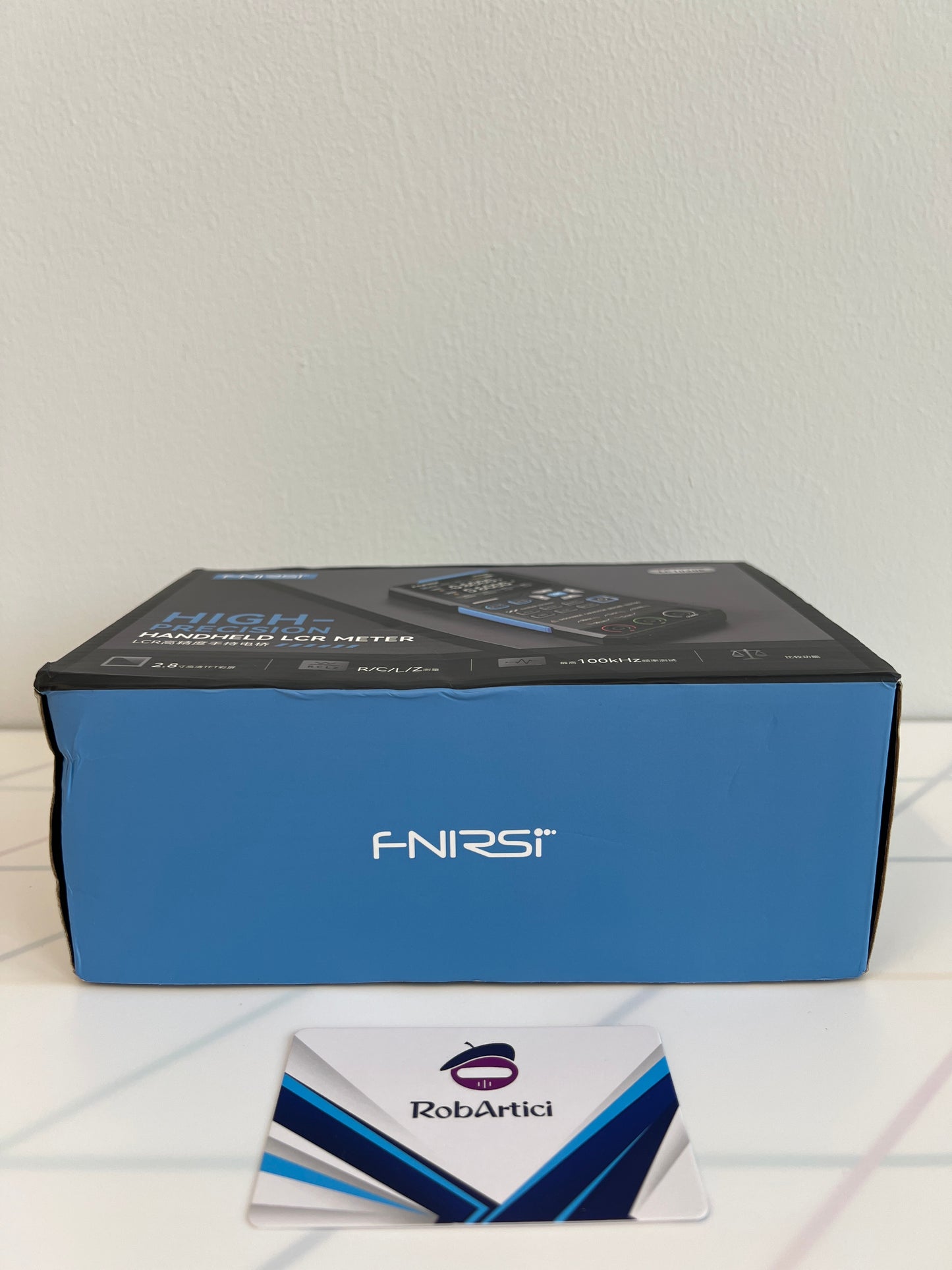 FNIRSI LC1020E handheld LCR meter retail packaging box side view